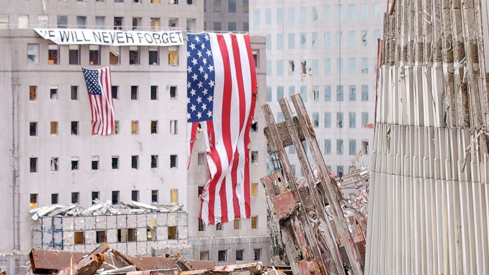 PHOTO: Flags hang on the side of buildings near the wreckage of the World Trade Center, Sept.25, 2001, in New York.