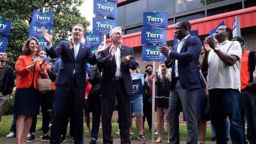 PHOTO: Virginia Governor Ralph Northam, second from left, talks about his  endorsement in the Democratic gubernatorial primary of former governor Terry McAuliffe, third  from left, during a quick rally in Richmond, Va., June 4, 2021. 