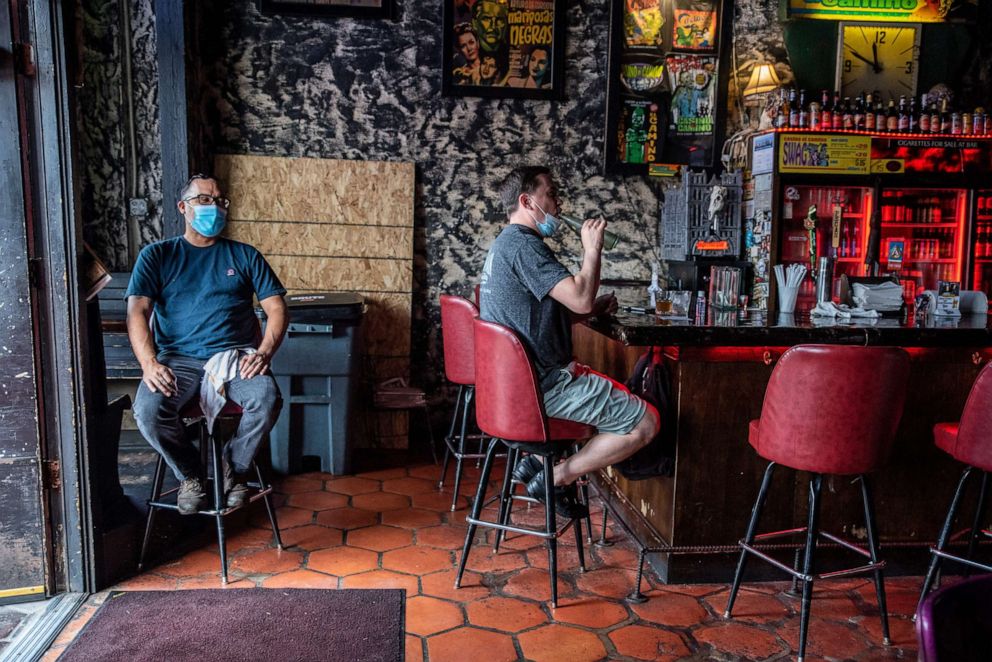 PHOTO: A man sits at the bar of a restaurant in Austin, Texas, June 26, 2020.