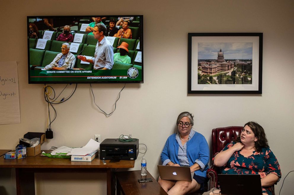 PHOTO: Andrea Greer and Maureen Haver listen to former U.S. Rep. Beto O'Rourke testify before lawmakers in opposition to Senate Bill 1 while they wait for their turn to testify at the State Capitol on July 10, 2021, in Austin, Texas.