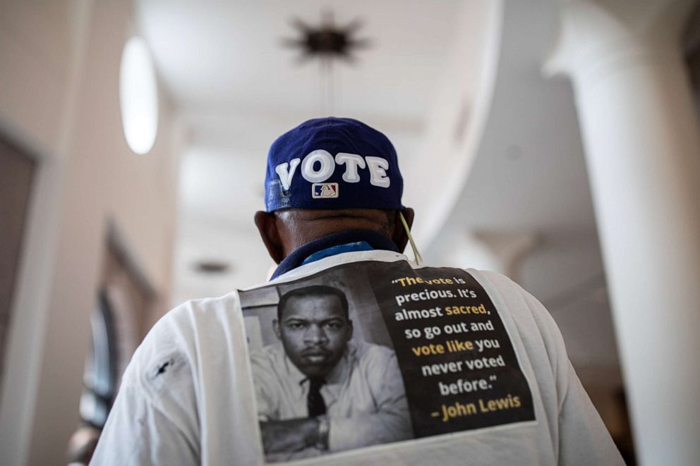 PHOTO: Edward Jones wears a baseball hat with the word Vote on it in the Texas State Capitol while he and others wait to testify before House and Senate committees, which began hearings on election integrity bills, on July 10, 2021 in Austin, Texas.