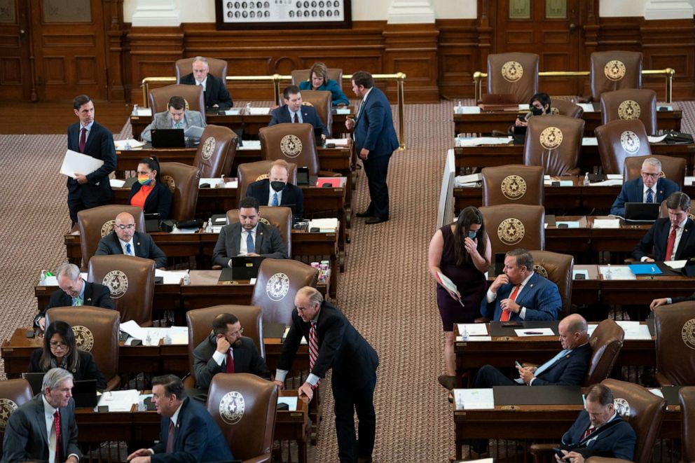 PHOTO: Texas House members confer as the Texas House considers HB1 the redistricting bill during the second-called 87th Legislature special session, Oct. 12, 2021, in Austin, Texas.