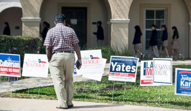 PHOTO: A voter stops to look at primary election signs outside the polling place at St. Annes Catholic Church on Tuesday, March 6, 2018, in Houston.