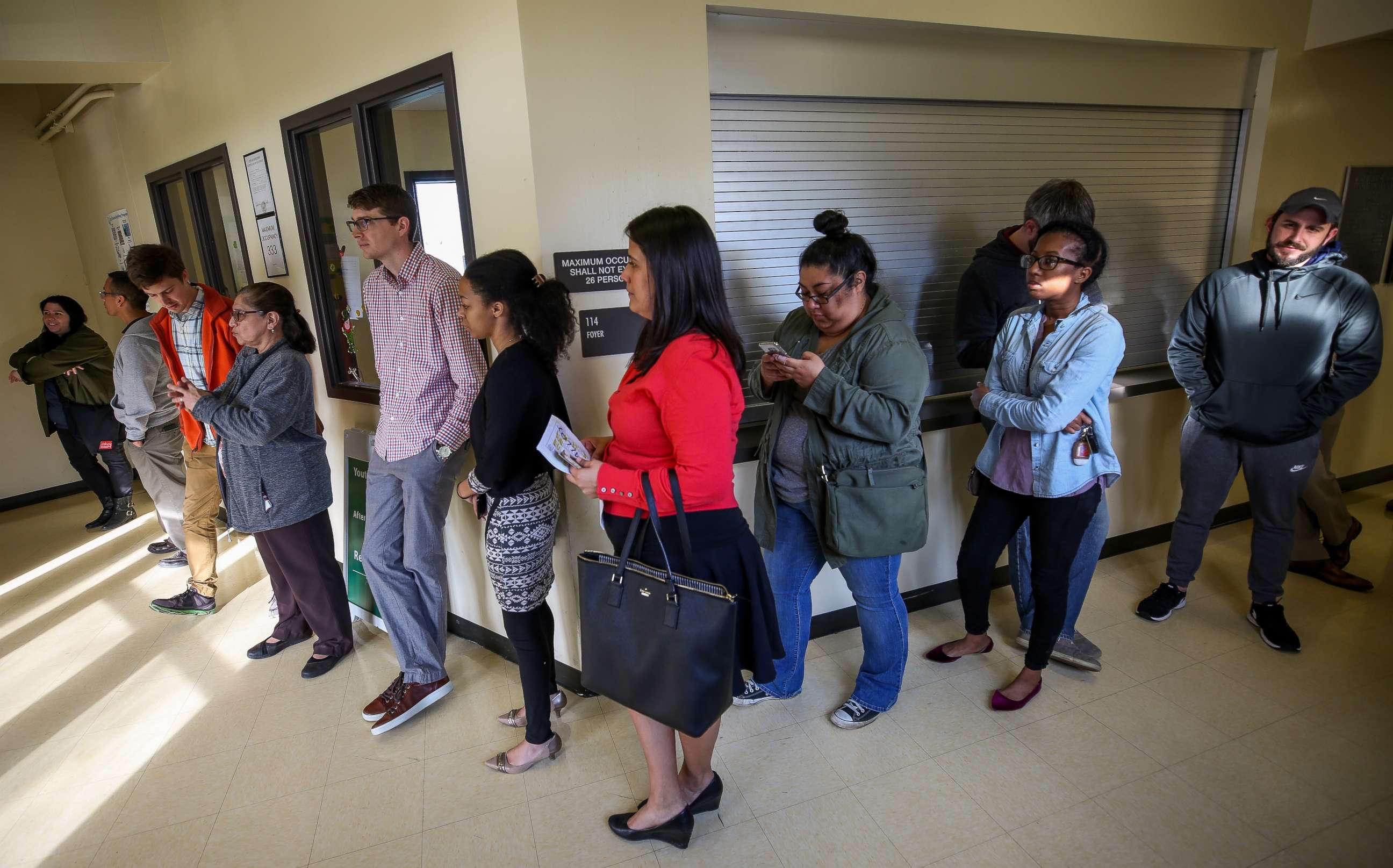 PHOTO: People wait in line to vote as officials work to resolved issues with polling machines at the Montie Beach Community Center on March 6, 2018, in Houston. 