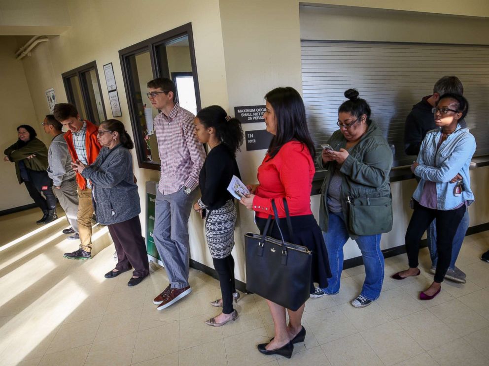 PHOTO: People wait in line to vote as officials work to resolved issues with polling machines at the Montie Beach Community Center on March 6, 2018, in Houston.
