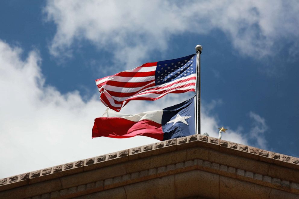 PHOTO: The Texas state flag and the U.S. flag wave in the wind above the Texas State Capitol building in Austin, Texas, Sept. 3, 2021.