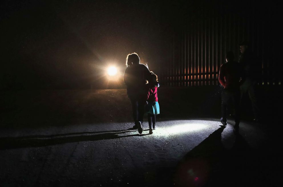 PHOTO: A Honduran mother walks with her children next to the U.S.-Mexico border fence as they turned themselves in to Border Patrol agents on February 22, 2018 near Penitas, Texas.