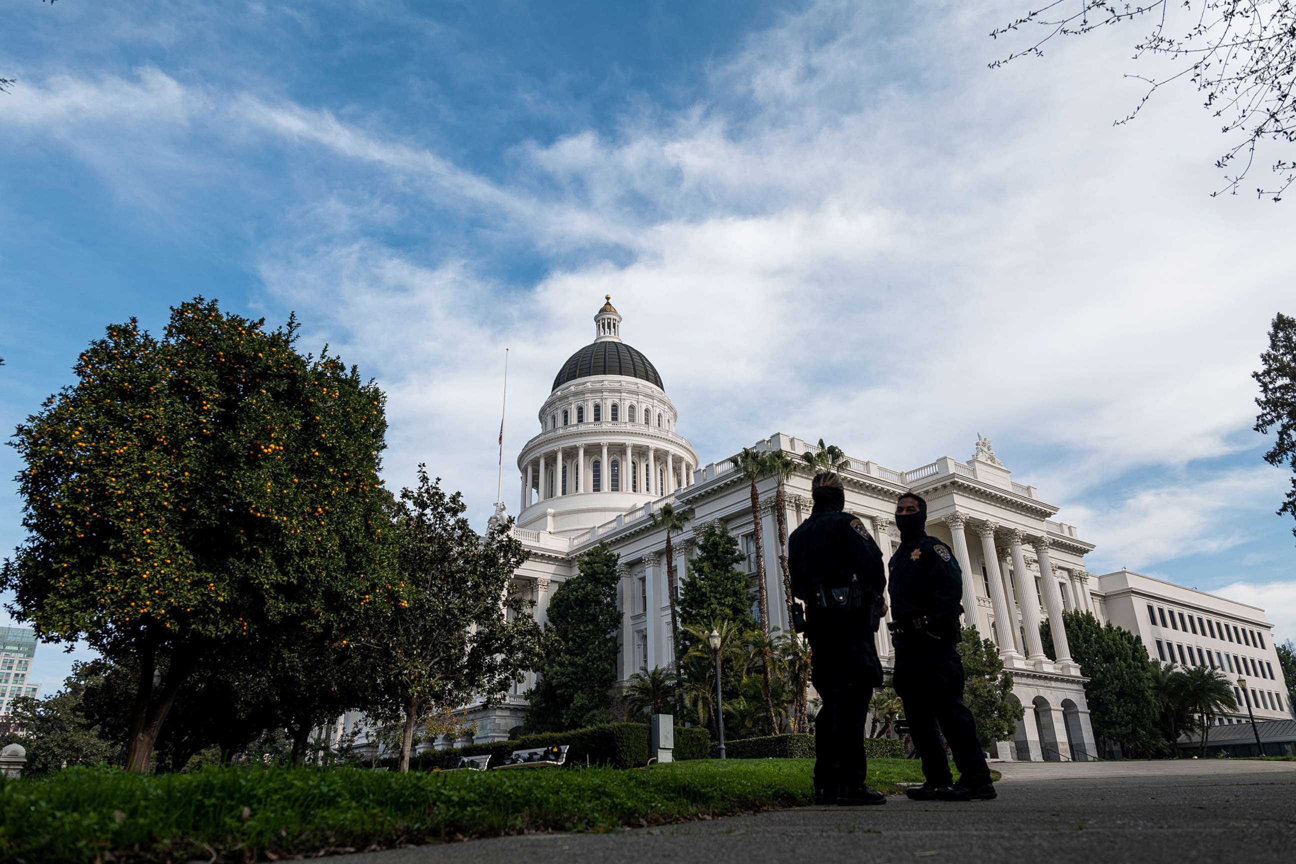 PHOTO: Members of the California Highway Patrol wearing protective masks stand outside the California State Capitol building in Sacramento, Calif., Jan. 15, 2021.