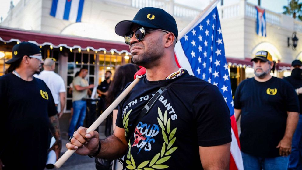 PHOTO: Henry "Enrique" Tarrio, leader of The Proud Boys, holds an American flag during a protest in Miami, July 16, 2021.