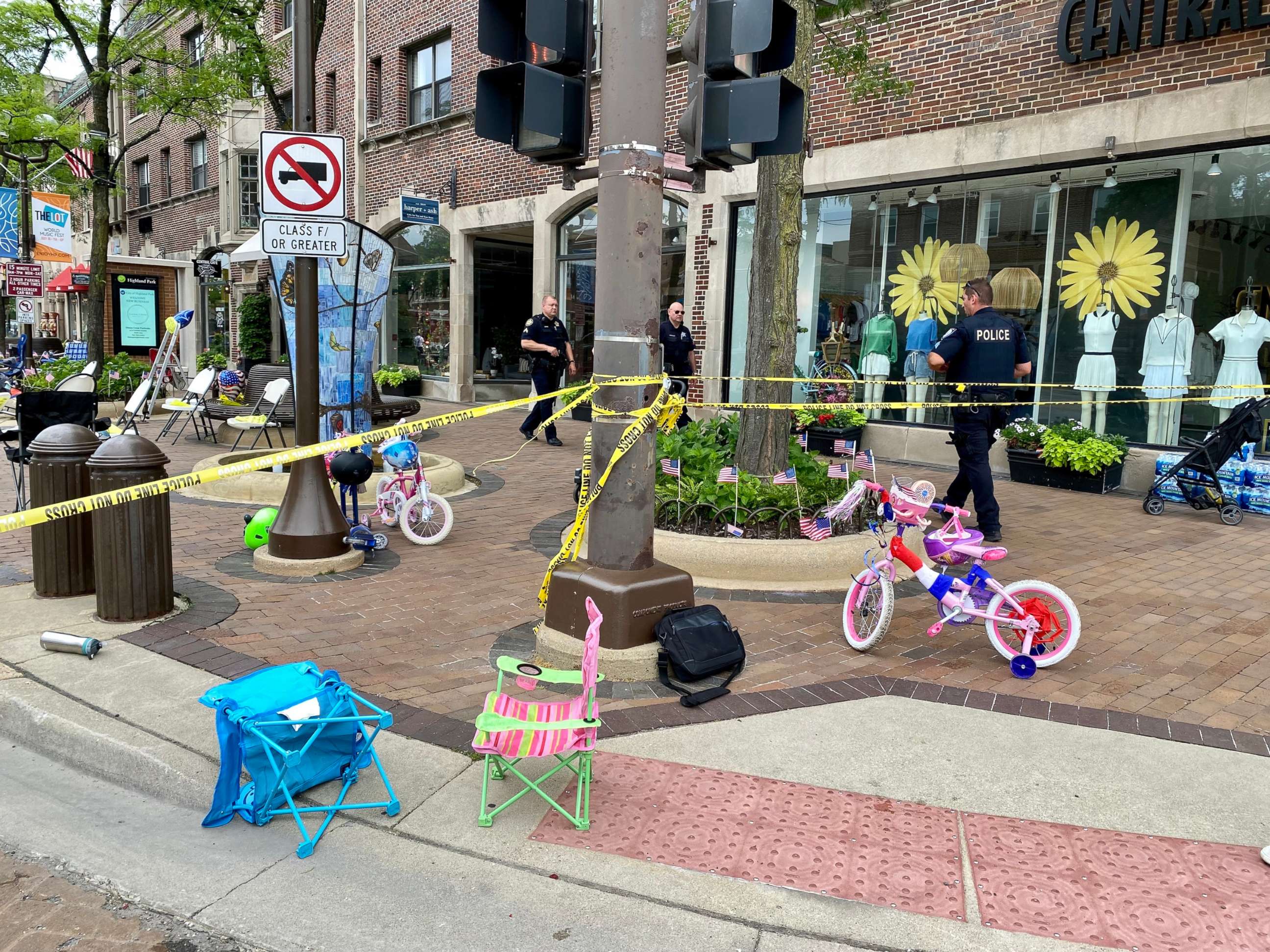 PHOTO: Law enforcement officers walk around a crime scene after a shooting at a Fourth of July parade in Highland Park, Ill., July 4, 2022.