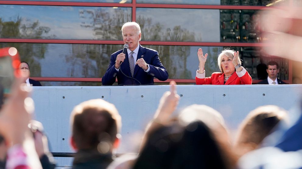 PHOTO: New Mexico Gov. Michelle Lujan Grisham, right, reacts as President Joe Biden speaks to an overflow crowd before a campaign rally Thursday, Nov. 3, 2022, in Albuquerque, N.M. 