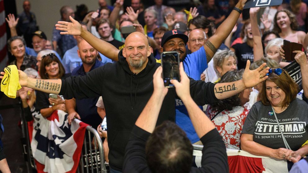PHOTO: John Fetterman, lieutenant governor of Pennsylvania and Democratic senate candidate, takes a photo with attendees after a campaign rally in Erie, Pa., Aug. 12, 2022.