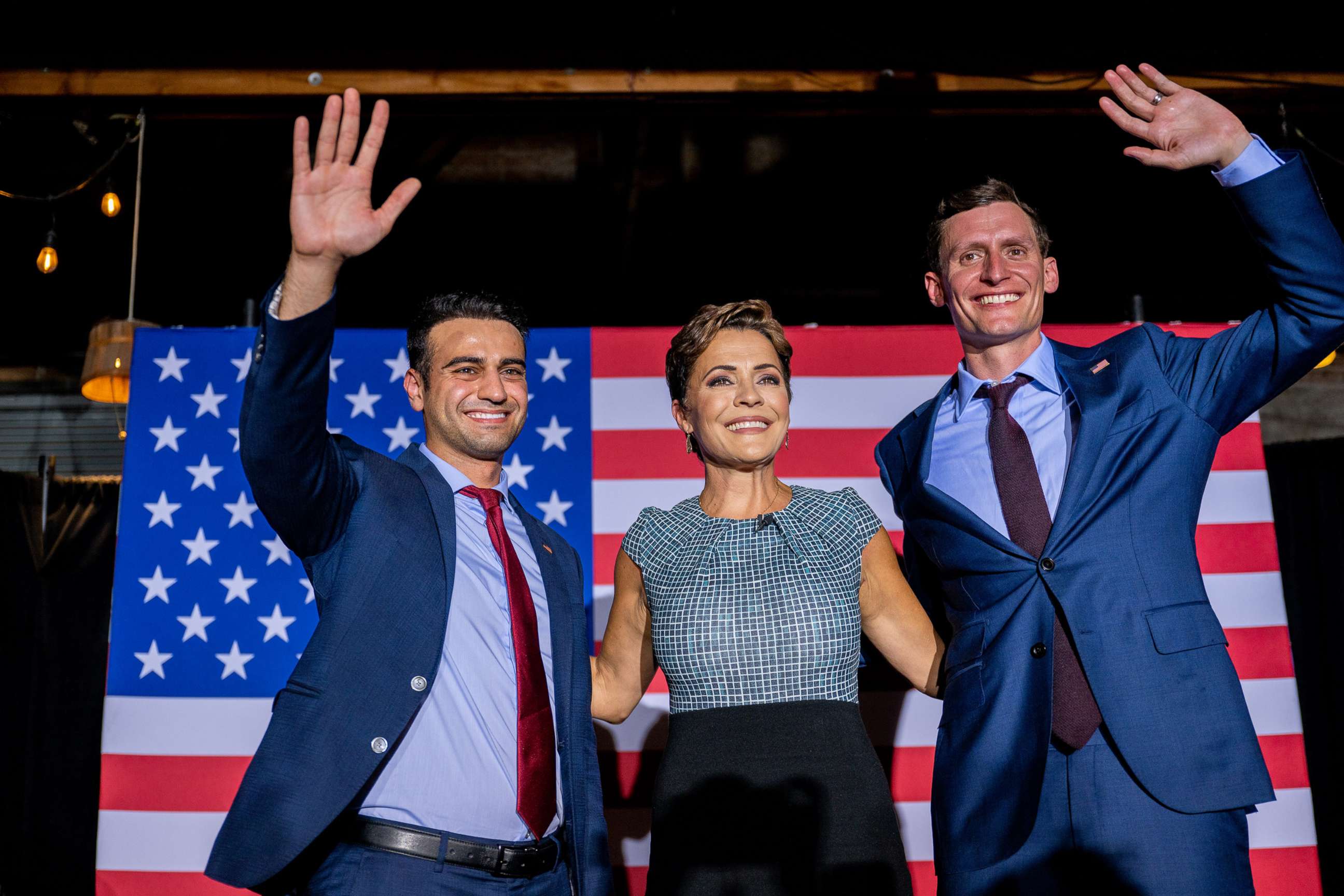 PHOTO: Republican candidate for state attorney general Abraham Hamadeh and Republican gubernatorial candidate Kari Lake  wave to supporters at the conclusion of a campaign event in Phoenix, Ariz., Aug. 01, 2022.