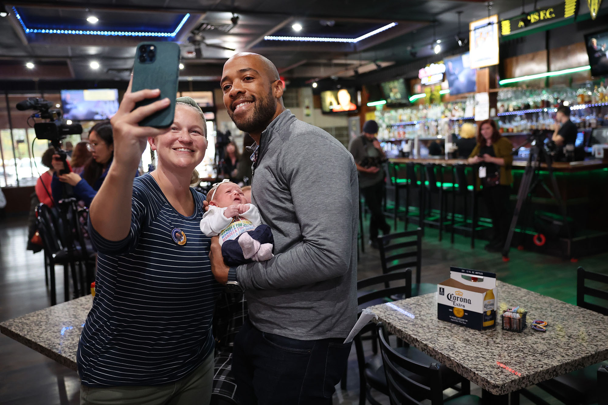 PHOTO: Democratic candidate for U.S. senate in Wisconsin Mandela Barnes poses for a picture with Mandi Miller and her 3-week-old daughter Lark during a campaign stop in West Allis, Wisc., Oct. 12, 2022.
