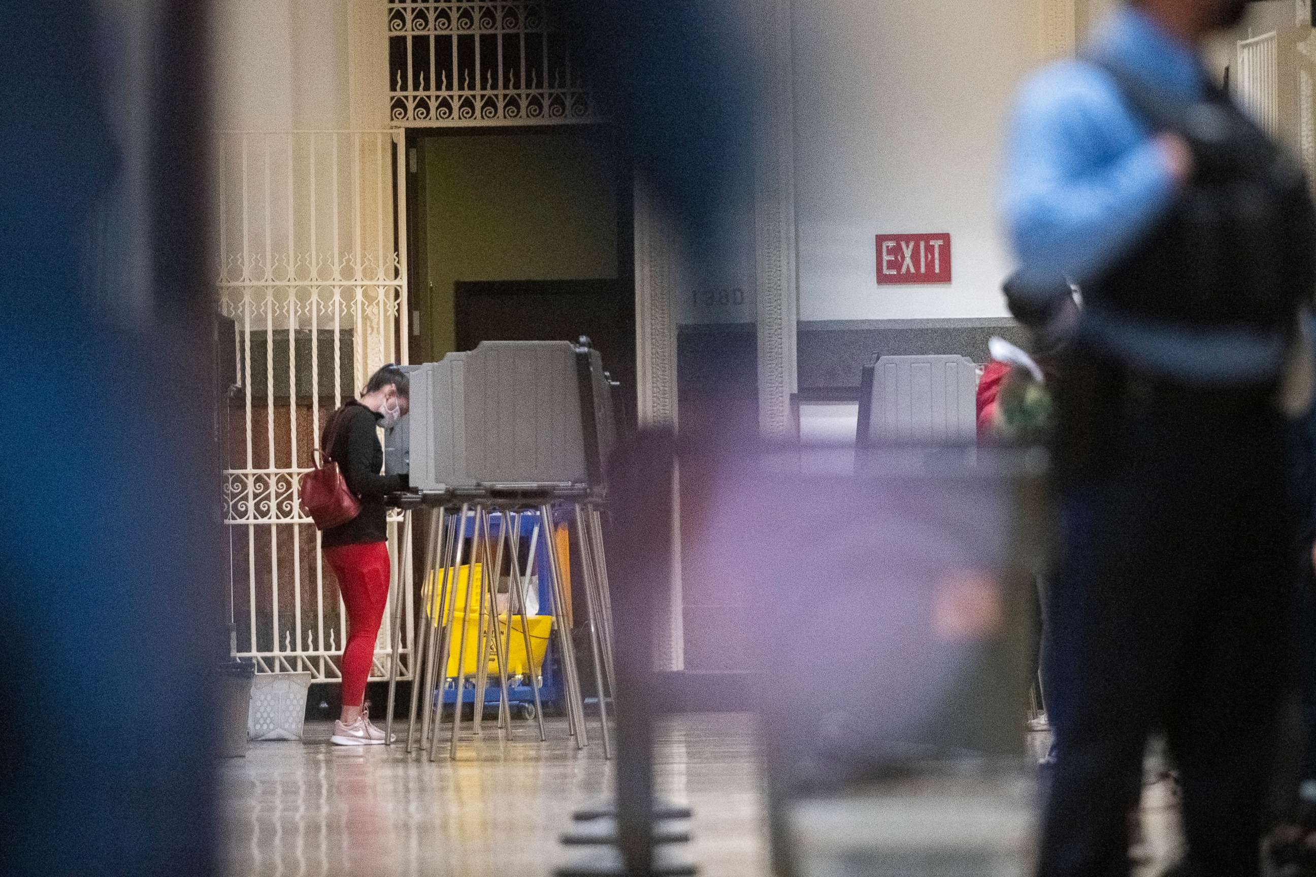 PHOTO: A woman casts her ballot at Philadelphia City Hall on the final day to vote early at a satellite polling station in Philadelphia, Oct. 27, 2020.