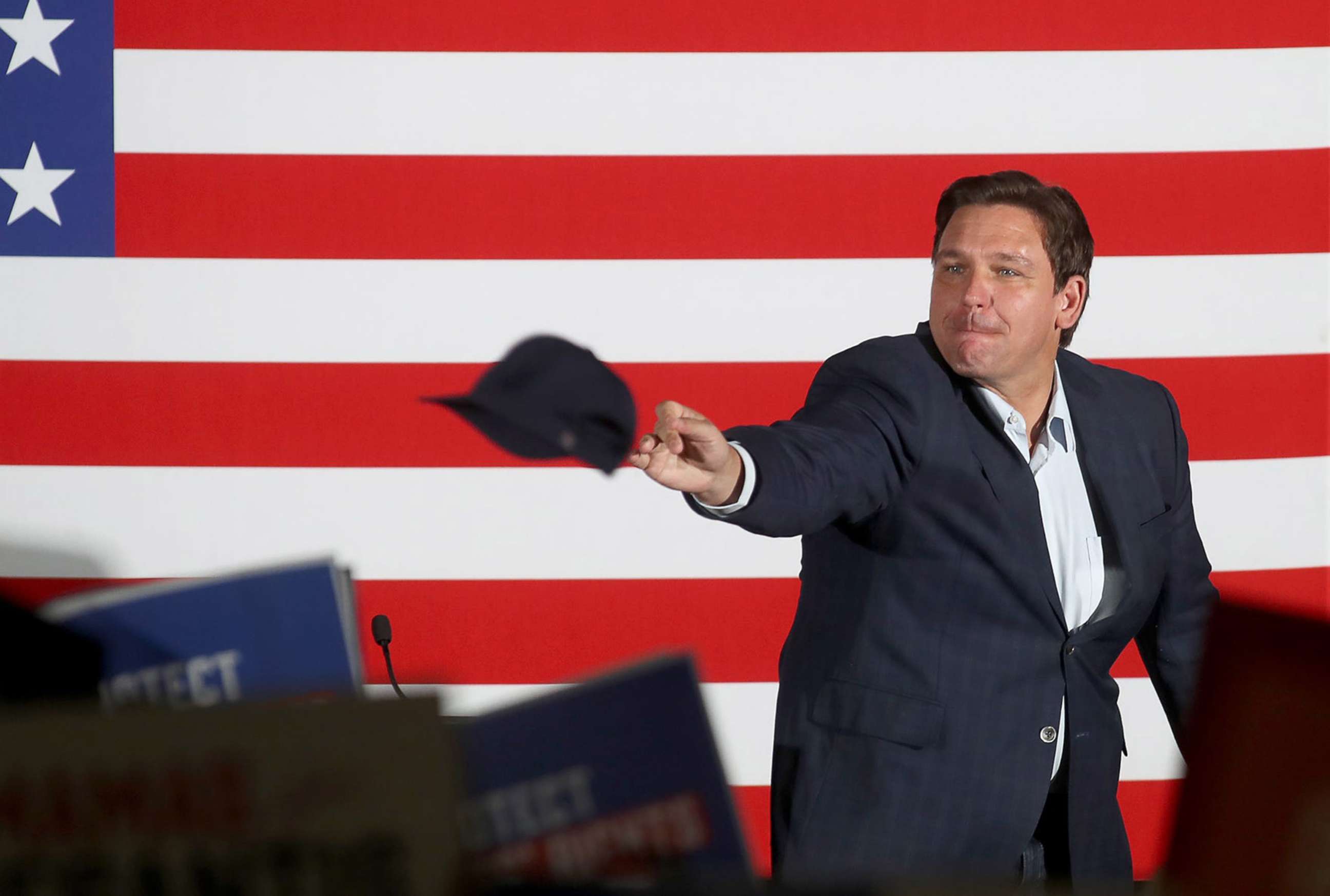 PHOTO: Florida Governor Ron DeSantis throws hats out to a crowd of supporters in Sarasota, Fla., Aug. 21, 2022.