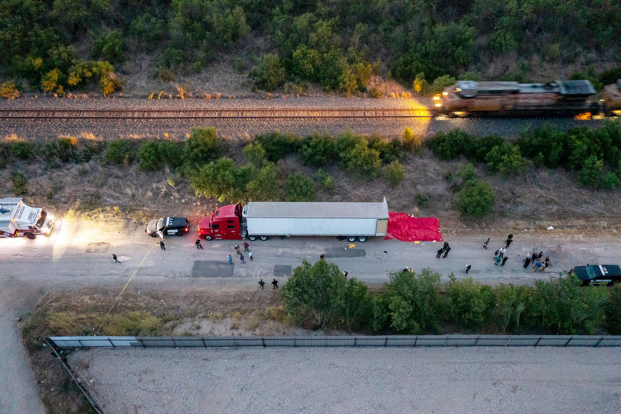 PHOTO: Members of law enforcement investigate the scene of the discovery of at least 46 people, believed to be migrant workers from Mexico, who were found dead in an abandoned tractor trailer in San Antonio, Texas, June 27, 2022.