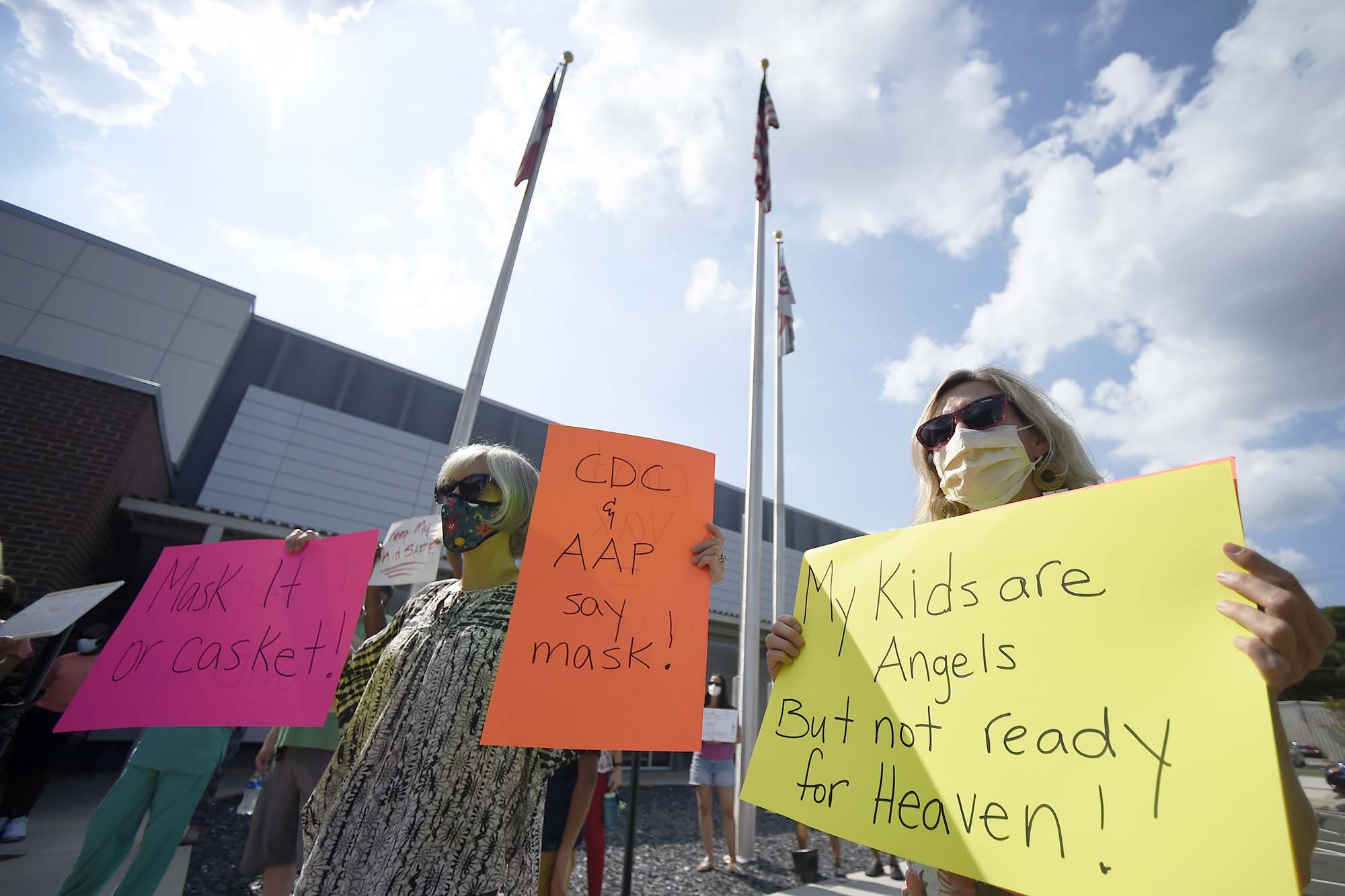 PHOTO: Pro-mask wearing demonstrators stage a protest at the Cobb County School Board Headquarters in Marietta, Ga., Aug. 12, 2021.