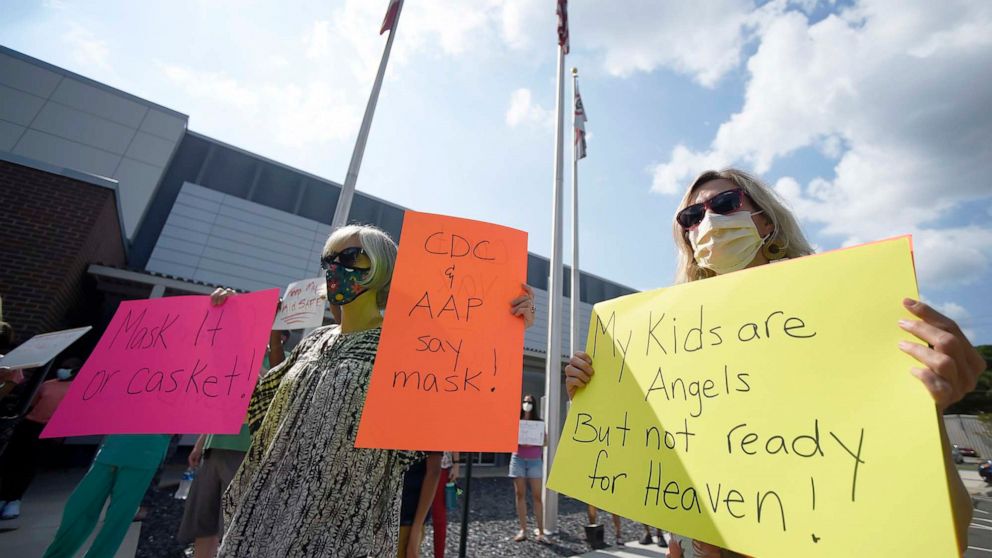 PHOTO: Pro-mask wearing demonstrators stage a protest at the Cobb County School Board Headquarters in Marietta, Ga., Aug. 12, 2021.