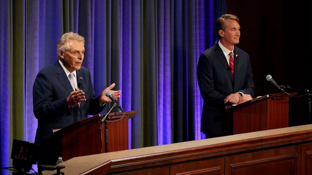PHOTO: Democratic gubernatorial candidate and former governor Terry McAuliffe, left, gestures as his Republican challenger, Glenn Youngkin, looks on during a debate at the Appalachian School of Law in Grundy, Va., Sept. 16, 2021.