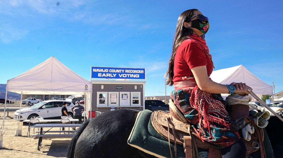 PHOTO: Activist Allie Young, of the Dine, leads a group of Native Americans as they ride on horseback to the polls in Kayenta, Ariz., Oct. 20, 2020. 