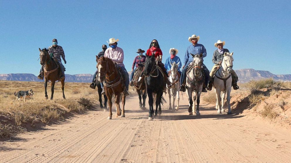 PHOTO: Members of Protect The Sacred, a grassroots initiative created by Navajo organizers, rode on horses to the voter polls in Kayenta, Ariz. on Oct. 20, 2020. 