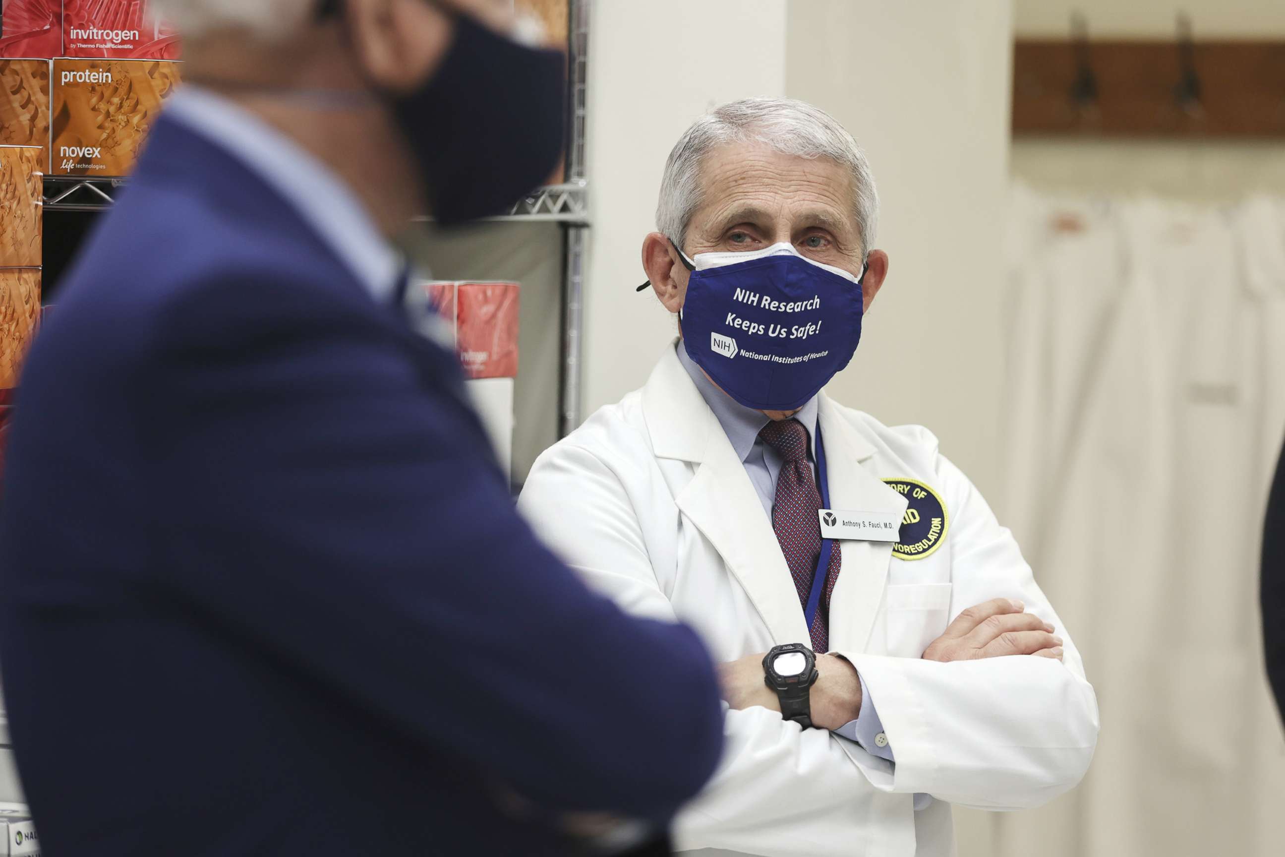 PHOTO: Anthony Fauci, director of the National Institute of Allergy and Infectious Diseases, wears a protective mask while listening to President Joe Biden, left, speak during a tour at the National Institutes of Health  in Bethesda, Md., Feb. 11, 2021.