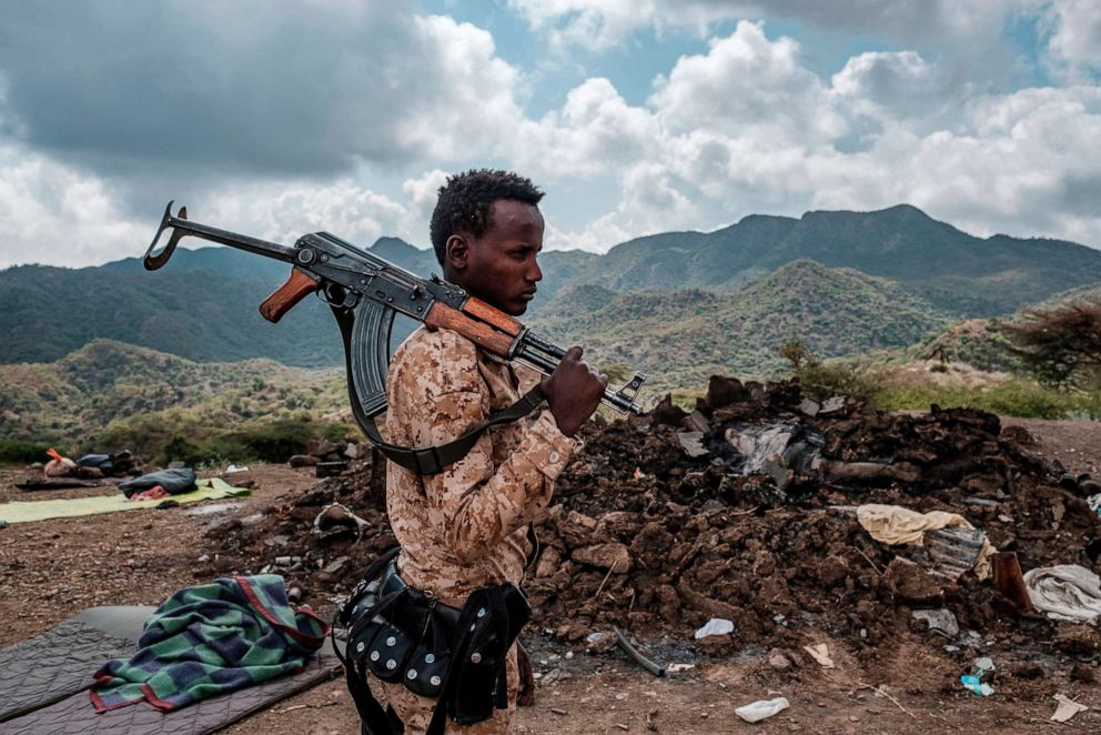 PHOTO: A member of the Afar Special Forces stands in front of the debris of a house in the outskirts of the village of Bisober, Tigray Region, Ethiopia, on Dec. 09, 2020.
