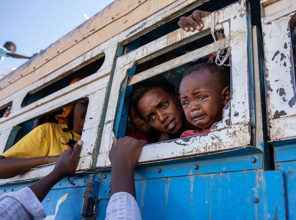 PHOTO: Tigray refugees who fled the conflict in the Ethiopia's Tigray region ride a bus going to the Village 8 temporary shelter near the Sudan-Ethiopia border, in Hamdayet, eastern Sudan on Dec. 1, 2020.