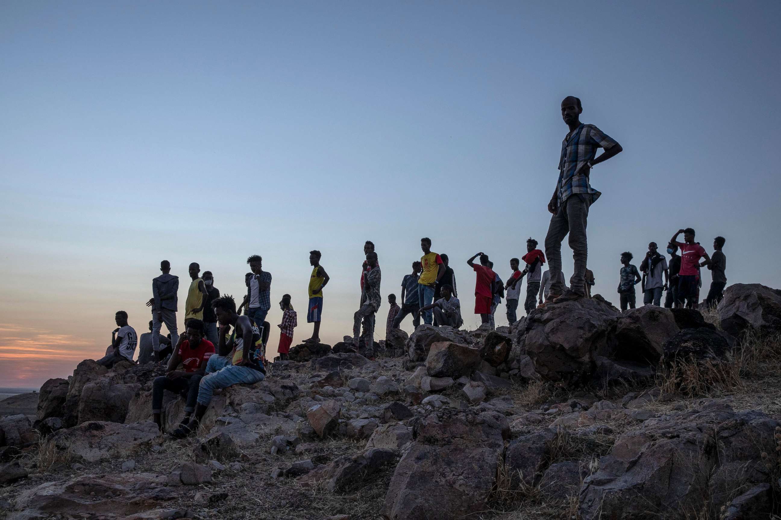 PHOTO: People who fled the conflict in Ethiopia's Tigray region, stand on a hill top over looking Umm Rakouba refugee camp in Qadarif, eastern Sudan, Nov. 26, 2020.