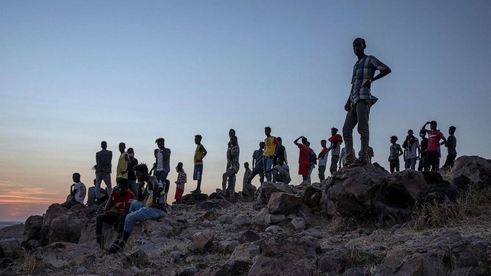 PHOTO: People who fled the conflict in Ethiopia's Tigray region, stand on a hill top over looking Umm Rakouba refugee camp in Qadarif, eastern Sudan, Nov. 26, 2020.