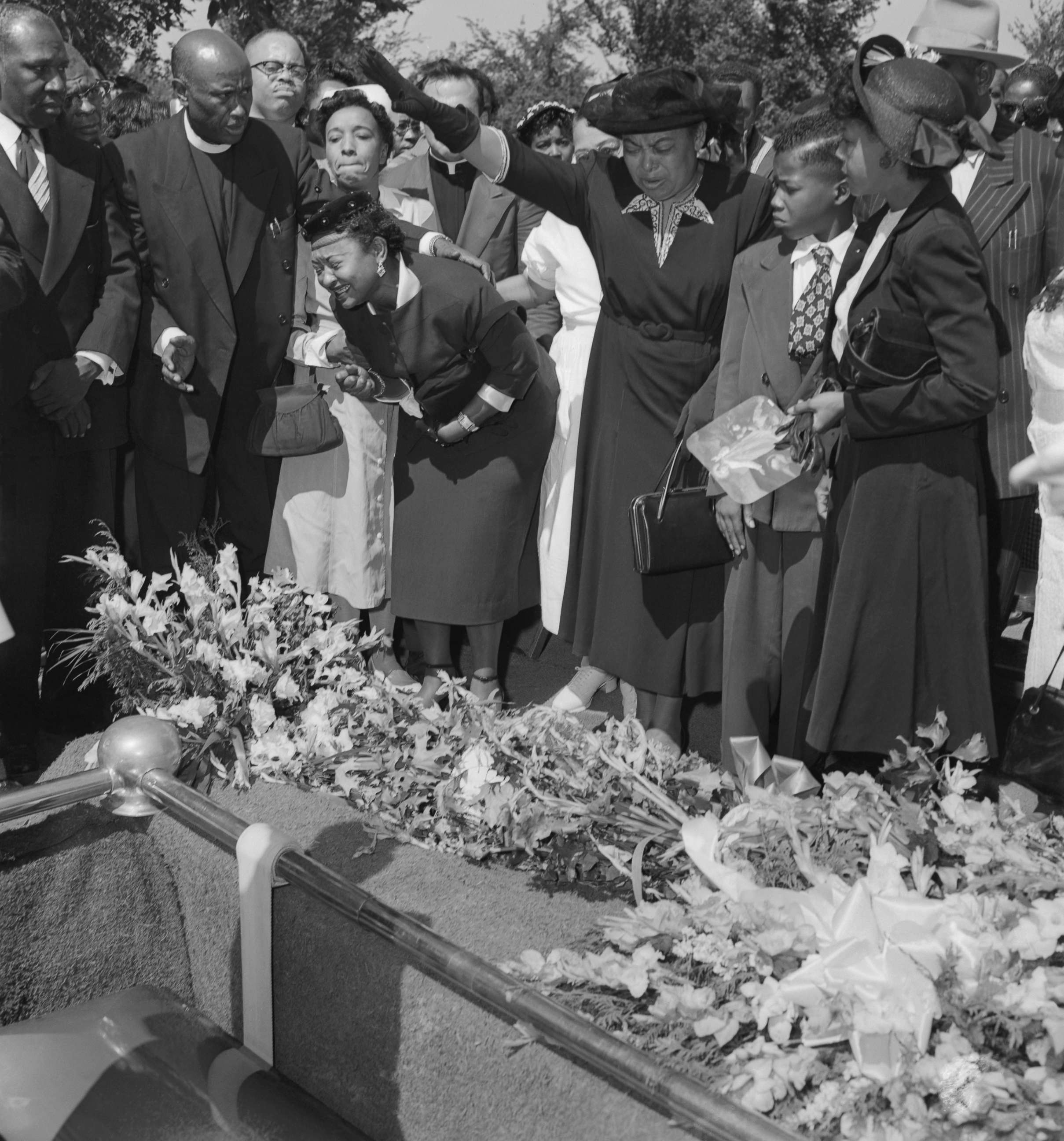PHOTO: Friends restrain grief-stricken Mrs. Mamie Bradley as her son Emmett Till's body is lowered into the grave after a four day, open casket funeral.