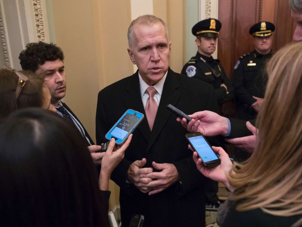 PHOTO: Sen. Thom Tillis, R-N.C., is surrounded by reporters as he makes his way to a closed-door GOP policy luncheon, at the Capitol, Jan. 4, 2018.