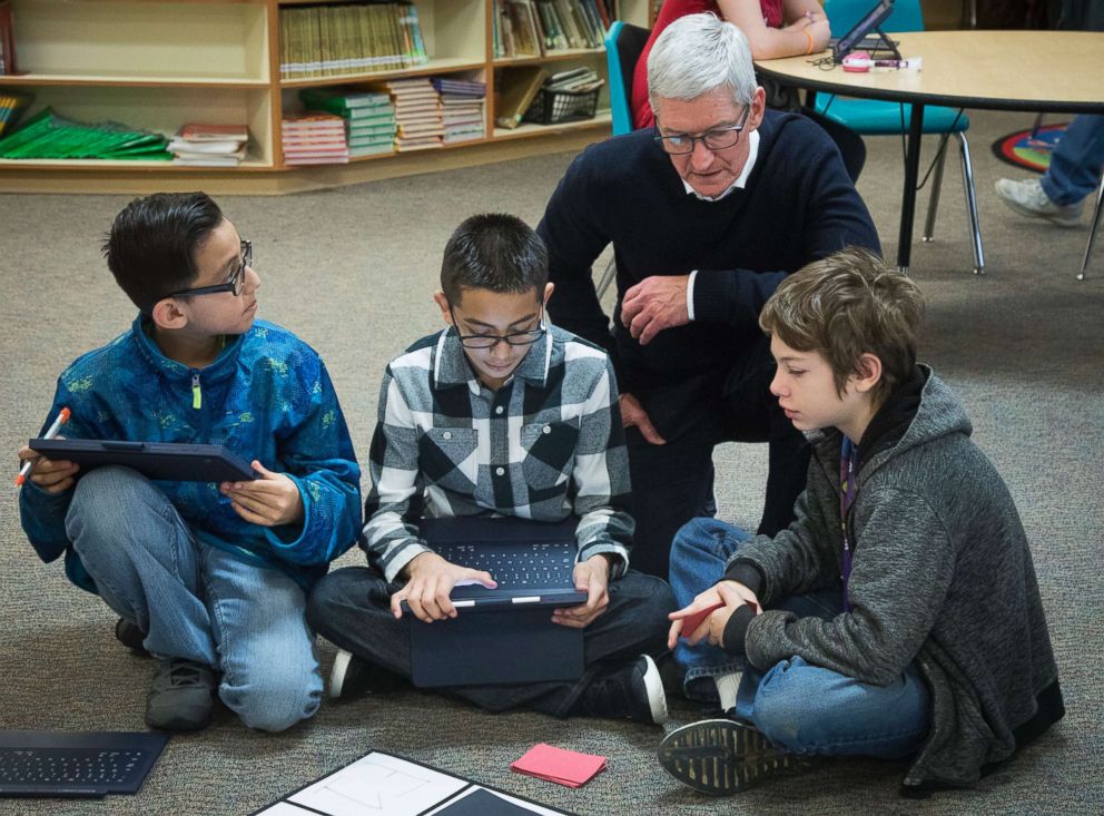 PHOTO: Apple CEO Tim Cook talks with Marco Aranjo, left, Fernny Flores, and Hunter Lansdell, about the coding they've done as they play a self-programmed game of Battleship at Wilder Elementary School, Nov. 27, 2018, in Boise, Idaho.