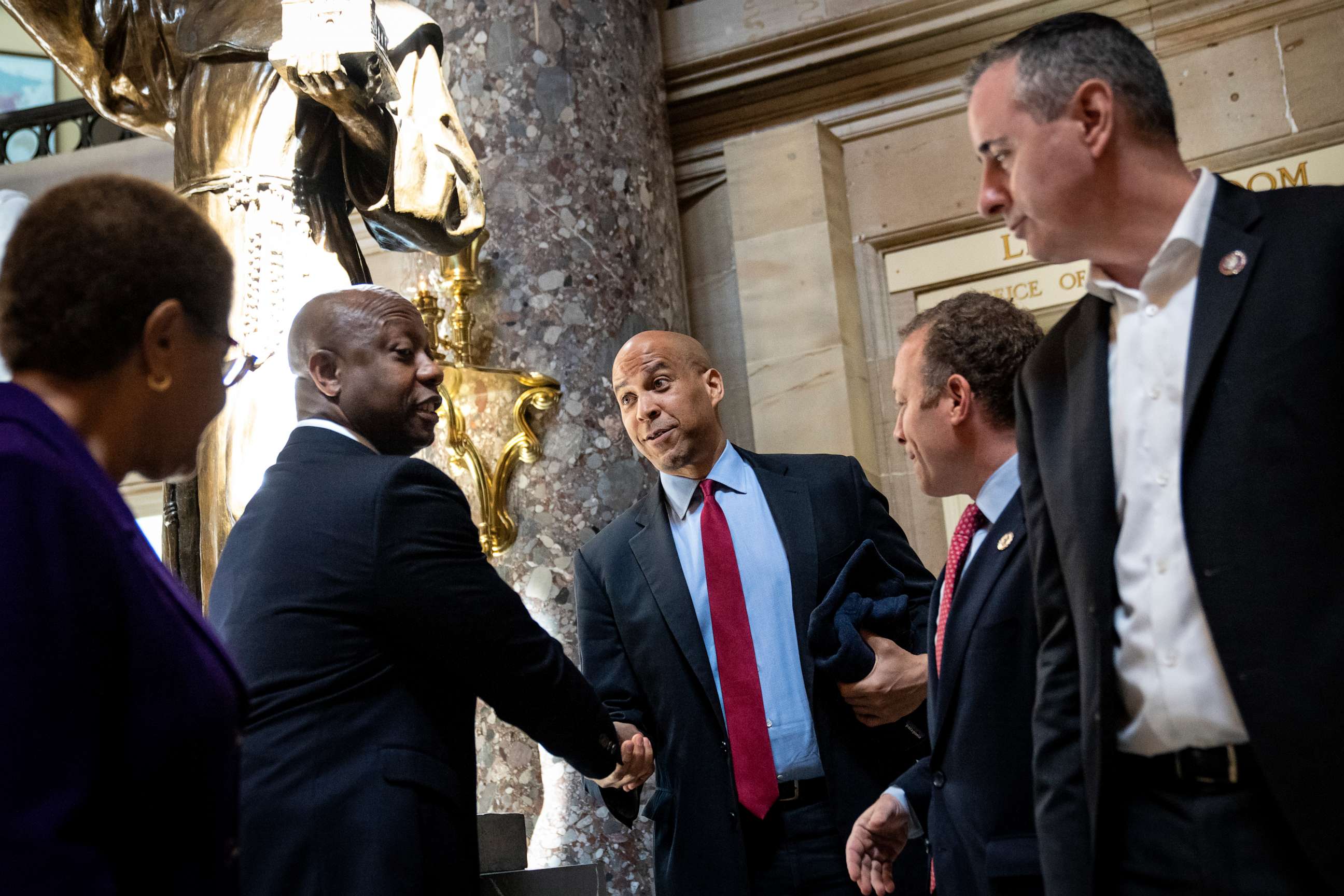 PHOTO: Sen. Tim Scott shakes hands with Sen. Cory Booker following a meeting about police reform legislation on Capitol Hill, May 18, 2021, in Washington.
