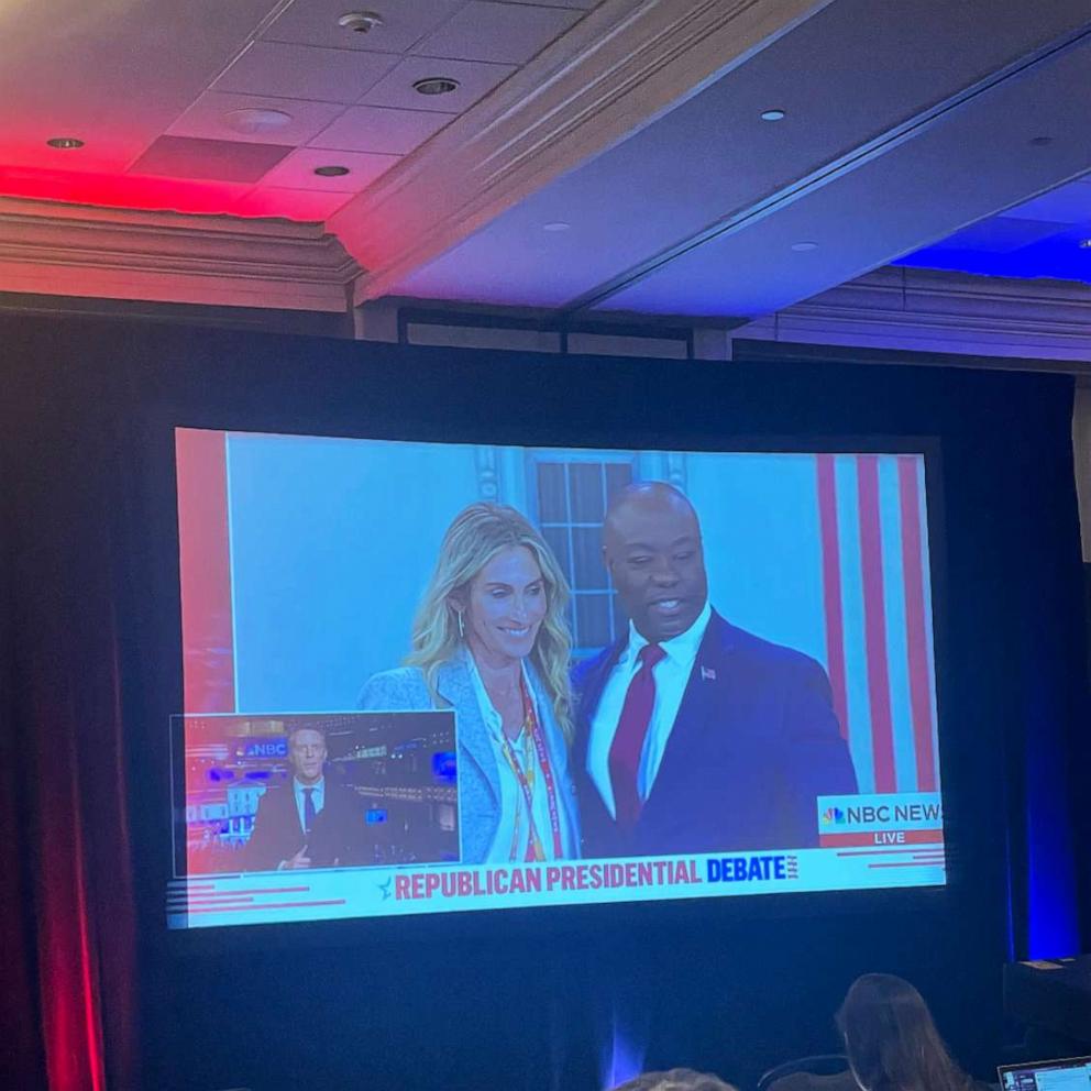 PHOTO: Sen. Tim Scott stands with a woman after the third Republican candidates' U.S. presidential debate in Miami, Fla., on Nov. 8, 2023.