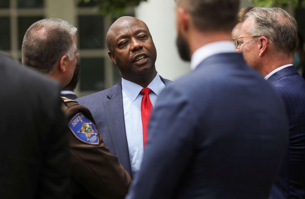 PHOTO: Sen. Tim Scott talks with law enforcement leaders at an event in the Rose Garden before President Donald Trump signed an executive order on police reform at the White House in Washington, June 16, 2020.