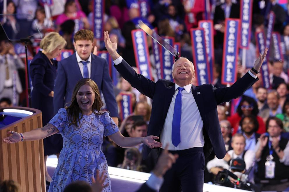 PHOTO: Democratic vice presidential nominee Minnesota Gov. Tim Walz reacts with his daughter Hope Walz after accepting the Democratic vice presidential nomination on Aug.21, 2024 in Chicago.