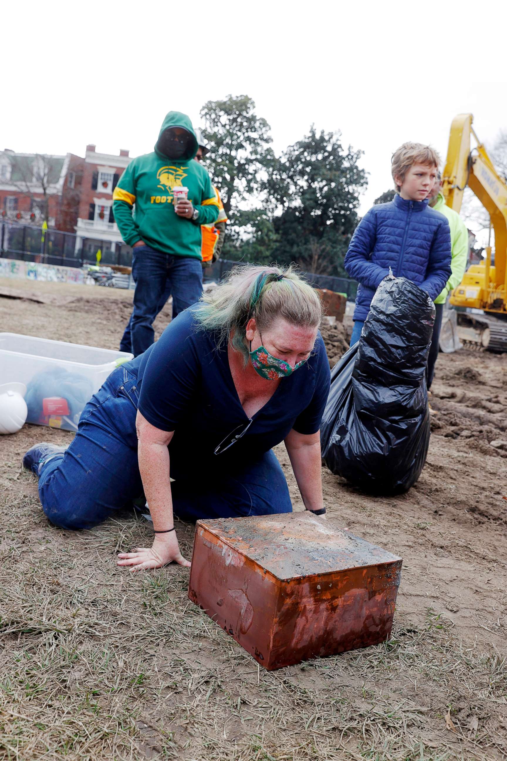 PHOTO: Katherine Ridgway, state archaeological conservator, prepares to wrap and remove a box believed to be the 1887 time capsule that was put under Confederate Gen. Robert E. Lee statue's pedestal in Richmond, Va., Dec. 27, 2021.