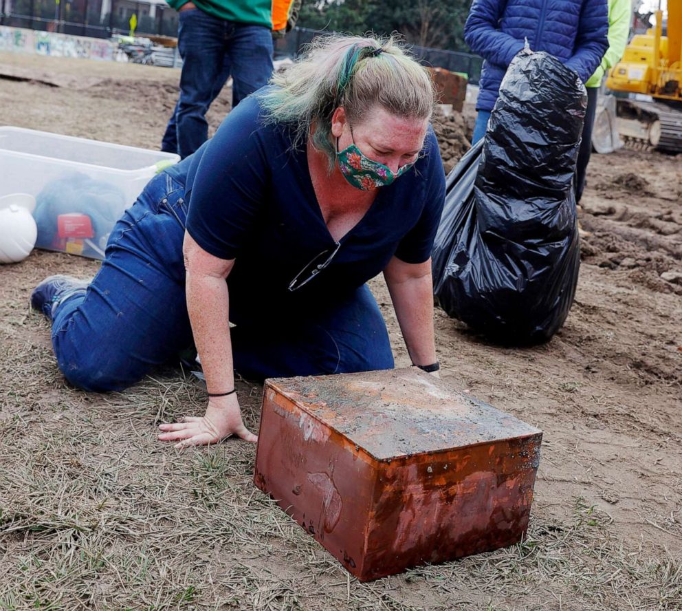 PHOTO: Katherine Ridgway, state archaeological conservator, prepares to wrap and remove a box believed to be the 1887 time capsule that was put under Confederate Gen. Robert E. Lee statue's pedestal in Richmond, Va., Dec. 27, 2021.