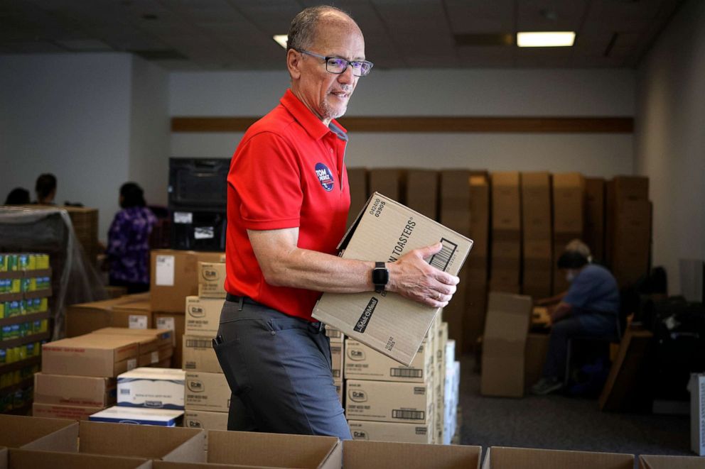 PHOTO: Maryland Democratic gubernatorial candidate Tom Perez helps pack boxes of food to be distributed to needy families at the Upcountry Food Hub, on July 15, 2022, in Germantown, Md.