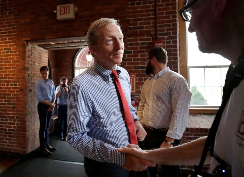 PHOTO: Democratic presidential candidate, businessman Tom Steyer shakes a hand during a campaign event, July 30, 2019, at the Waterworks Cafe in Manchester, N.H.