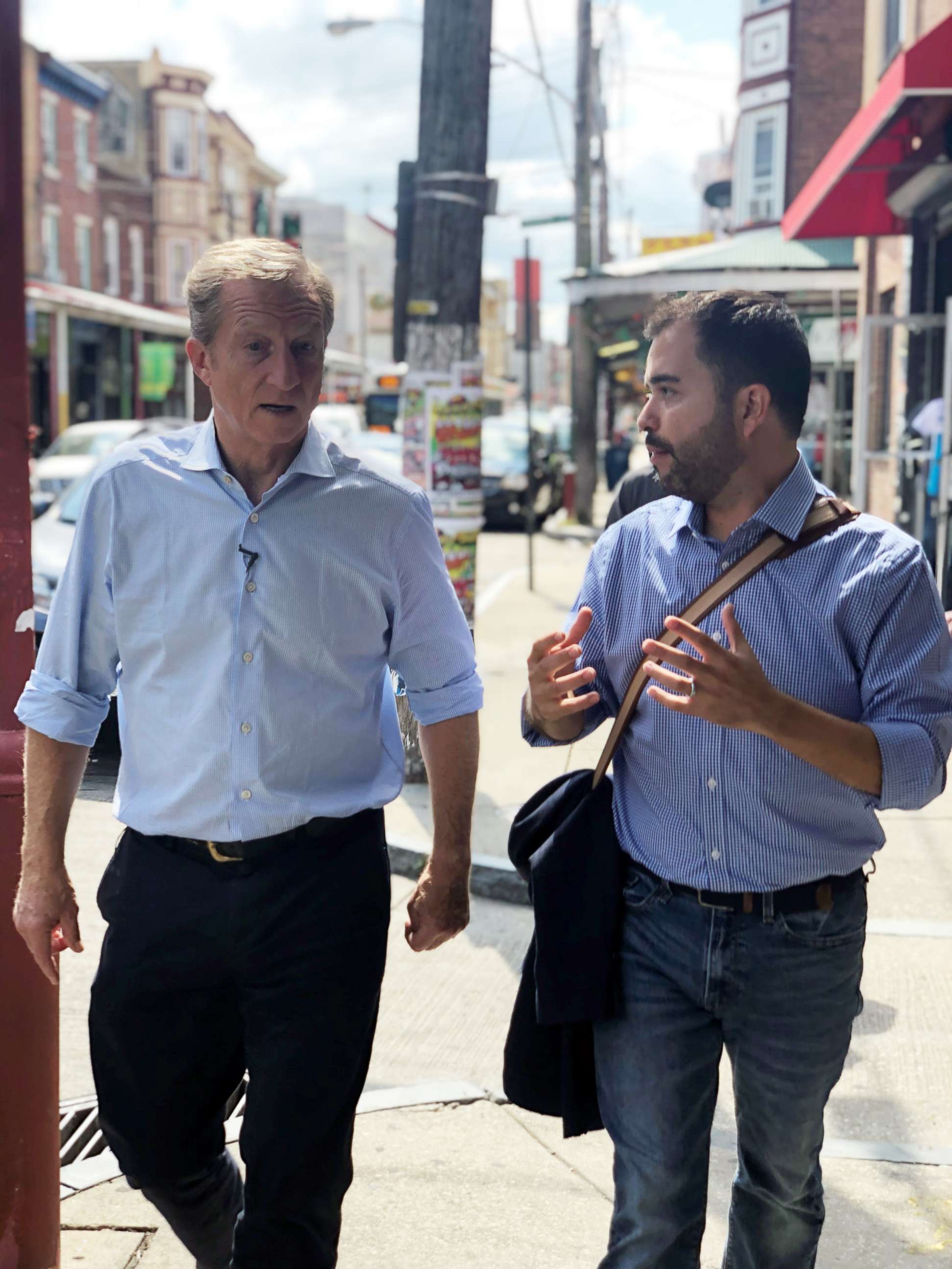 PHOTO: Tom Steyer walks with an aide during a campaign stop in South Philadelphia, Sept. 18, 2019.