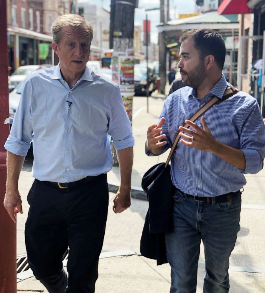 PHOTO: Tom Steyer walks with an aide during a campaign stop in South Philadelphia, Sept. 18, 2019.