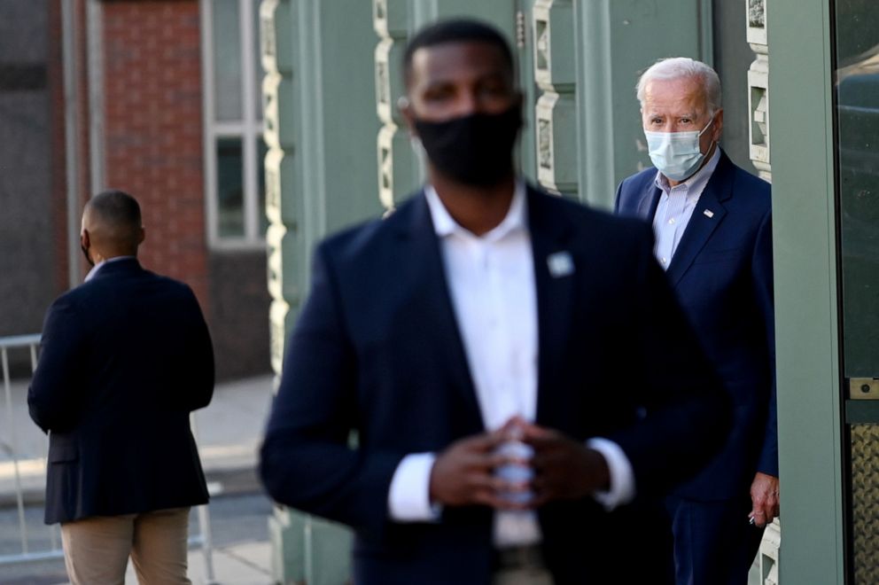 PHOTO: Democratic presidential nominee and former Vice President Joe Biden is surrounded by secret service agents as he exits a local theatre after participating in a virtual town hall meeting in Wilmington, Del., Oct. 3, 2020.