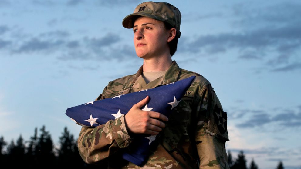 Capt. Jennifer Peace holds a flag as she stands for a photo near her home in Spanaway, Wash., Aug. 28, 2015. Peace is one of an estimated 15,000 transgender people who serve in the active-duty military. She has been deployed around the world, including Iraq and Afghanistan.  
