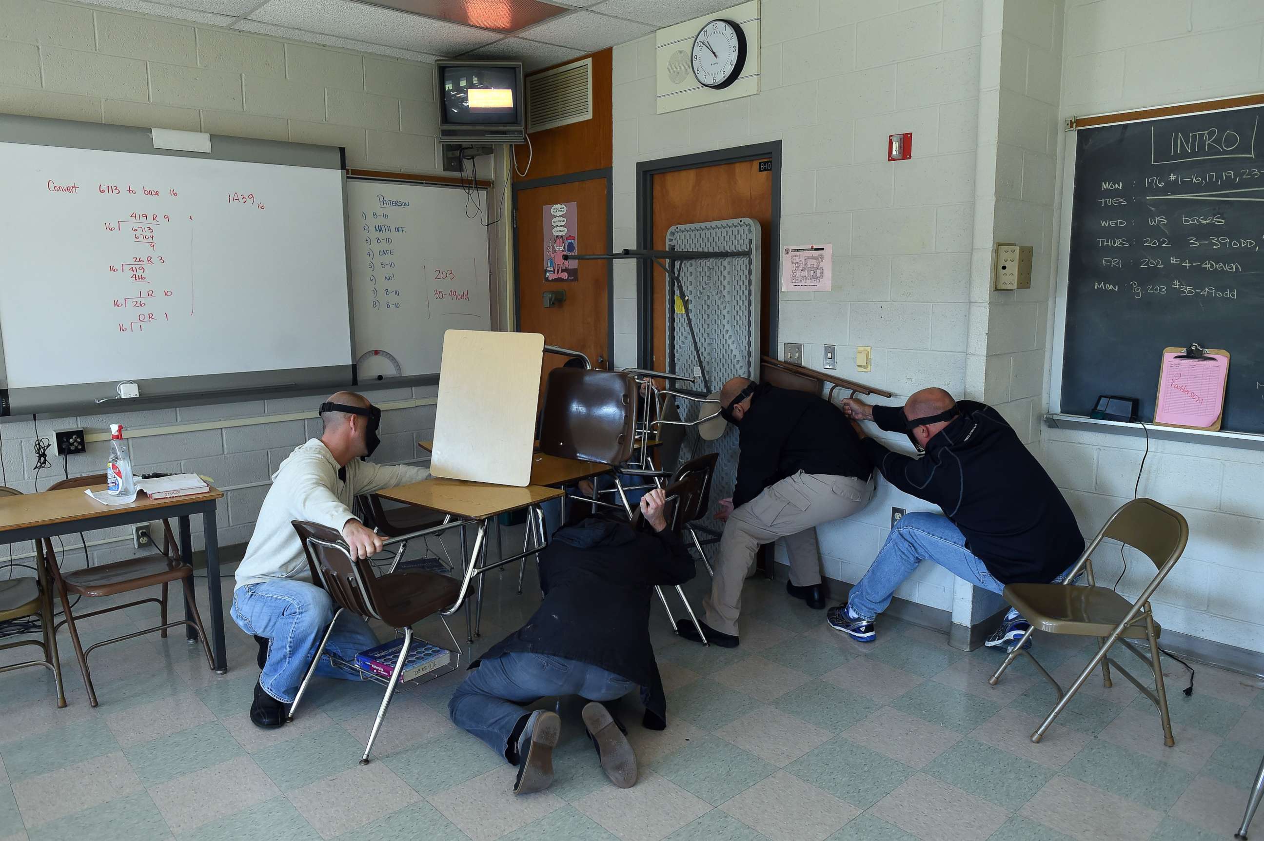 PHOTO: "Students" participating in a training session, barricade a door of a classroom to block an "active shooter" during ALICE (Alert, Lockdown, Inform, Counter and Evacuate) at the Harry S. Truman High School in Levittown, Pennsylvania, Nov. 3, 2015. 