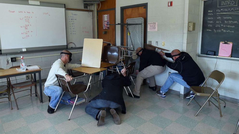 PHOTO: "Students" participating in a training session, barricade a door of a classroom to block an "active shooter" during ALICE (Alert, Lockdown, Inform, Counter and Evacuate) at the Harry S. Truman High School in Levittown, Pennsylvania, Nov. 3, 2015. 