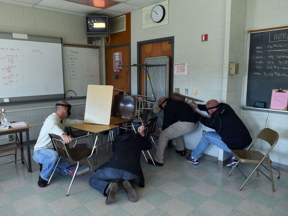 PHOTO: Students participating in a training session, barricade a door of a classroom to block an active shooter during ALICE (Alert, Lockdown, Inform, Counter and Evacuate) at the Harry S. Truman High School in Levittown, Pennsylvania, Nov. 3, 2015.