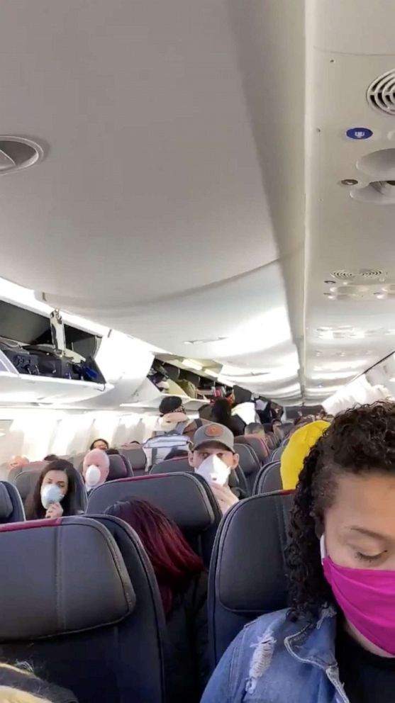 PHOTO: Passengers are seen onboard of American Airlines flight 388 at John F. Kennedy International Airport in New York, April 25, 2020.